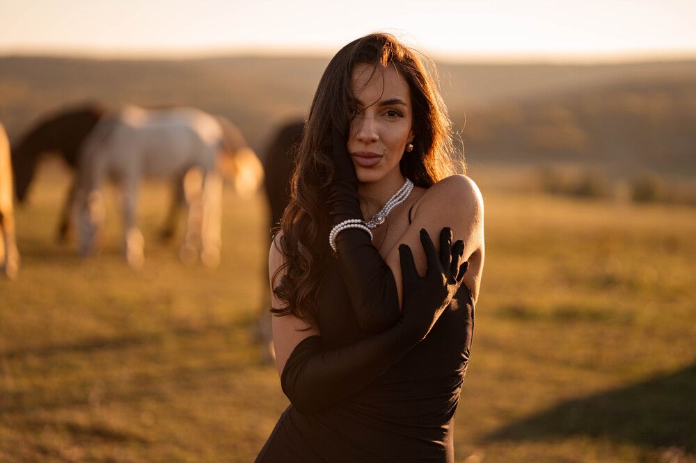 beautiful woman in field with horses
