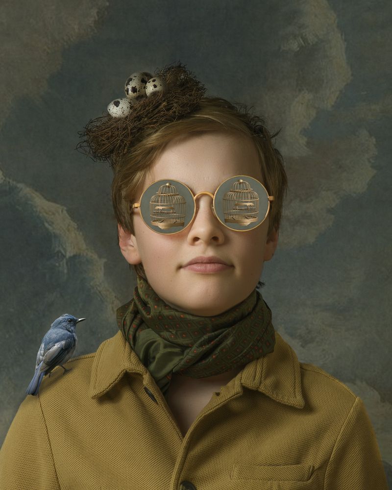 Boy with glasses and bird