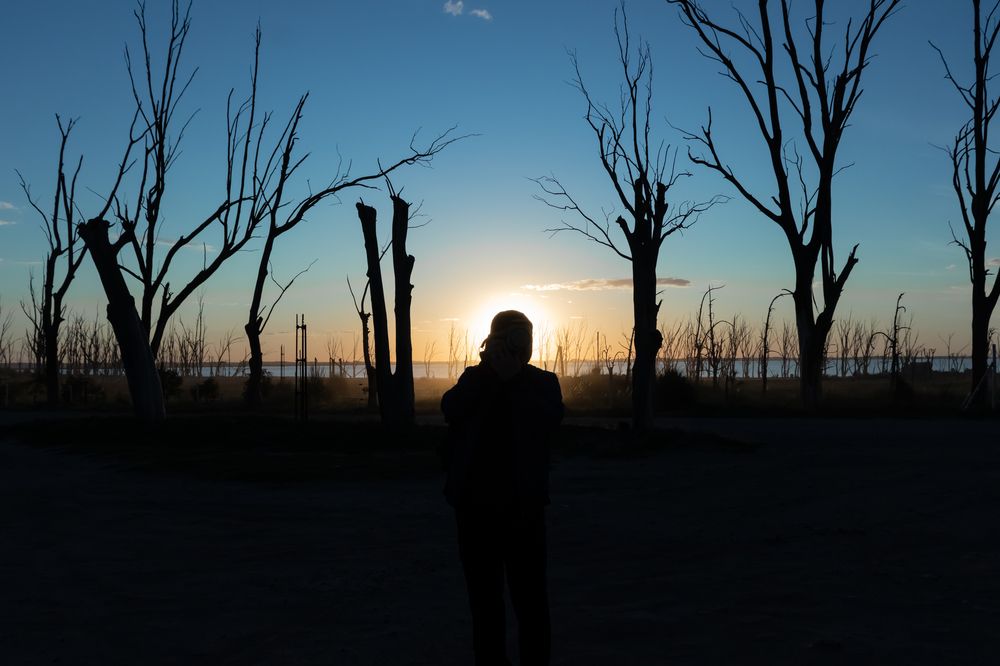 Between the sun and the camera.