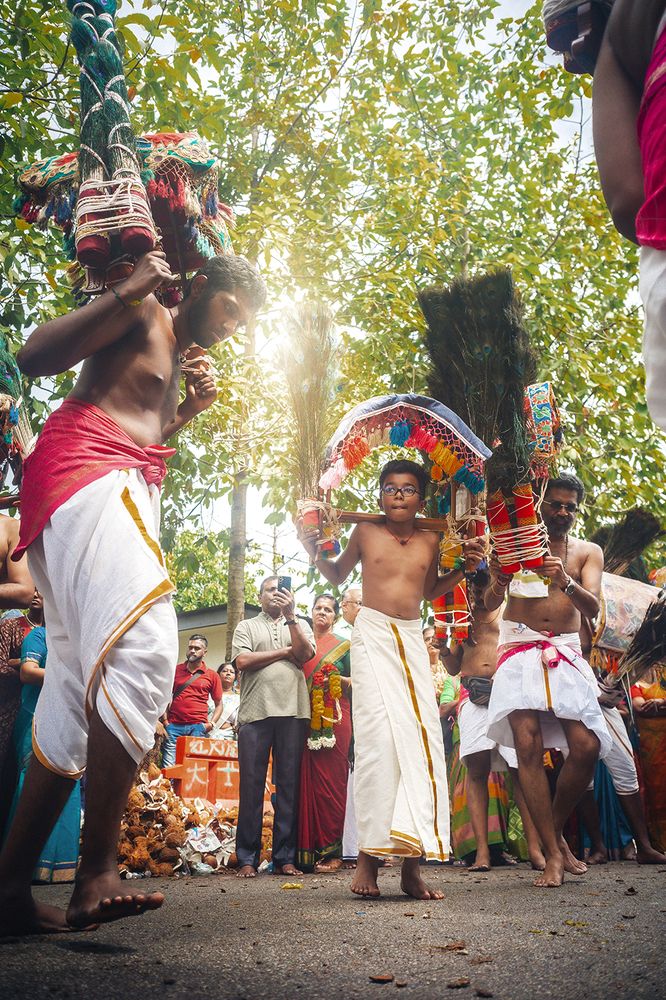 Devotees carry kavadi