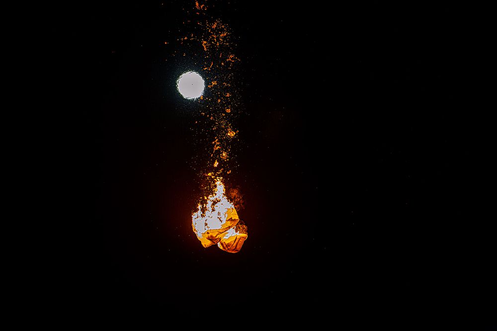 The moon’s silent witness to a burning dream.