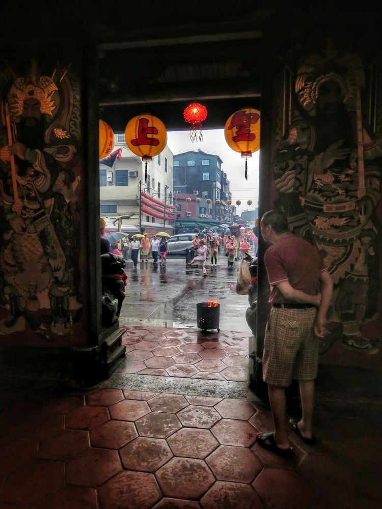 Piety in the rain outside the door