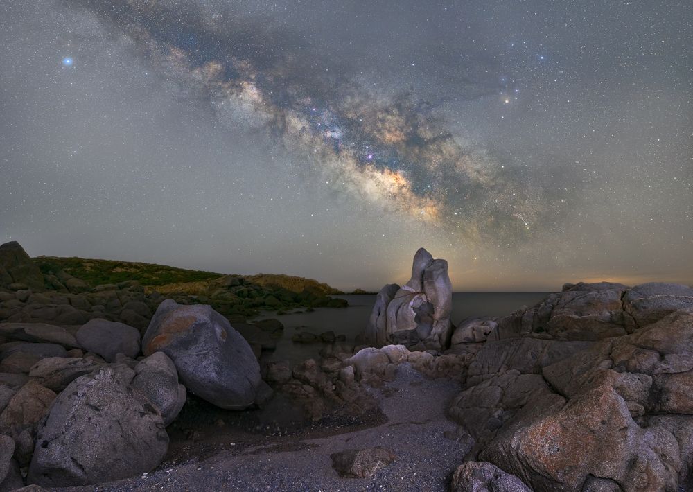 The milky way emerges over the bay