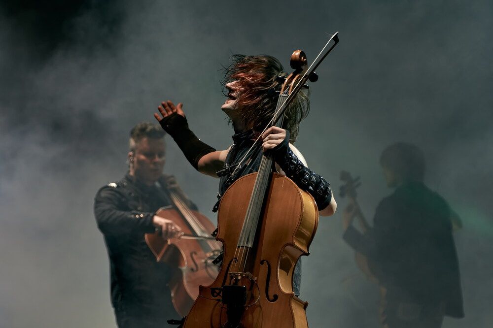 Cellist in the ecstasy of a rock music concert
