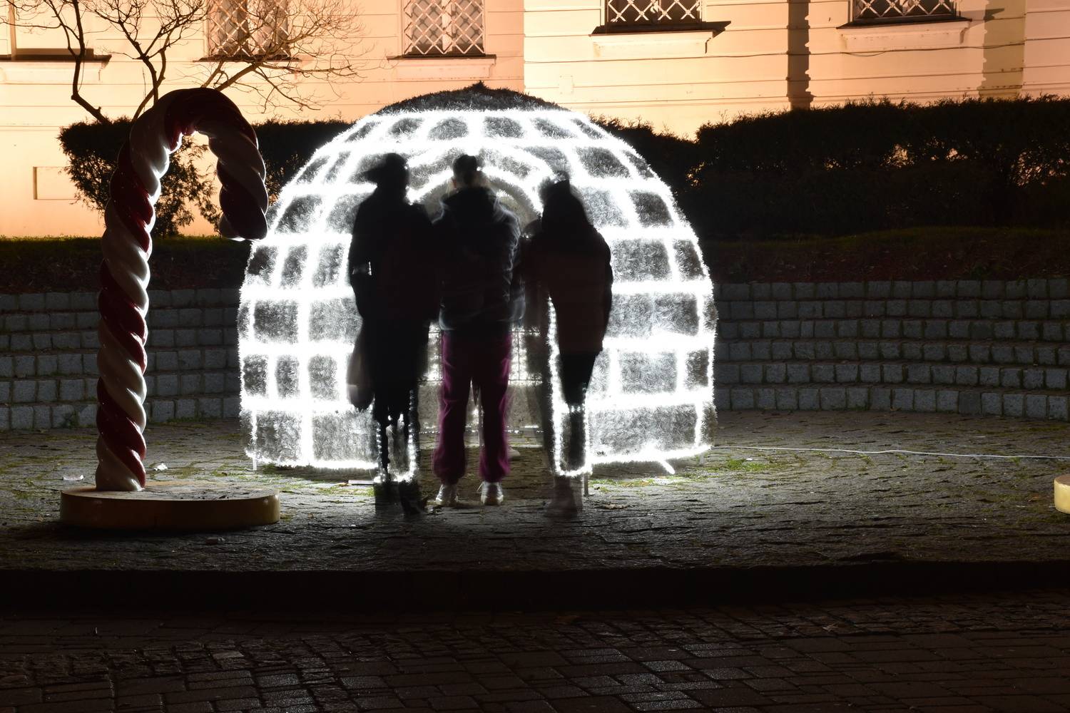 Three young people looked at the igloo Three young people looked at the igloo