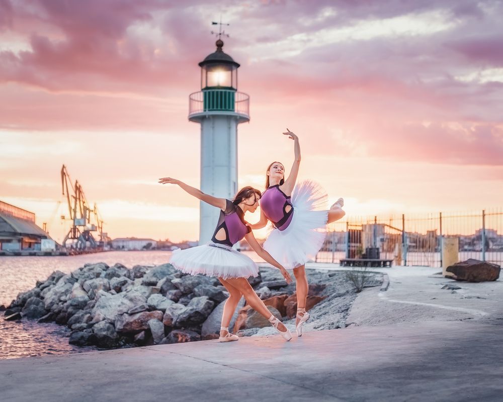 Dancing ballerinas at sunset on the harbor