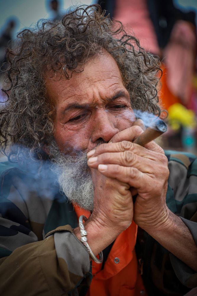 \"Life etched in every wrinkle, wisdom, struggle, and a moment of solace in the smoke.\"