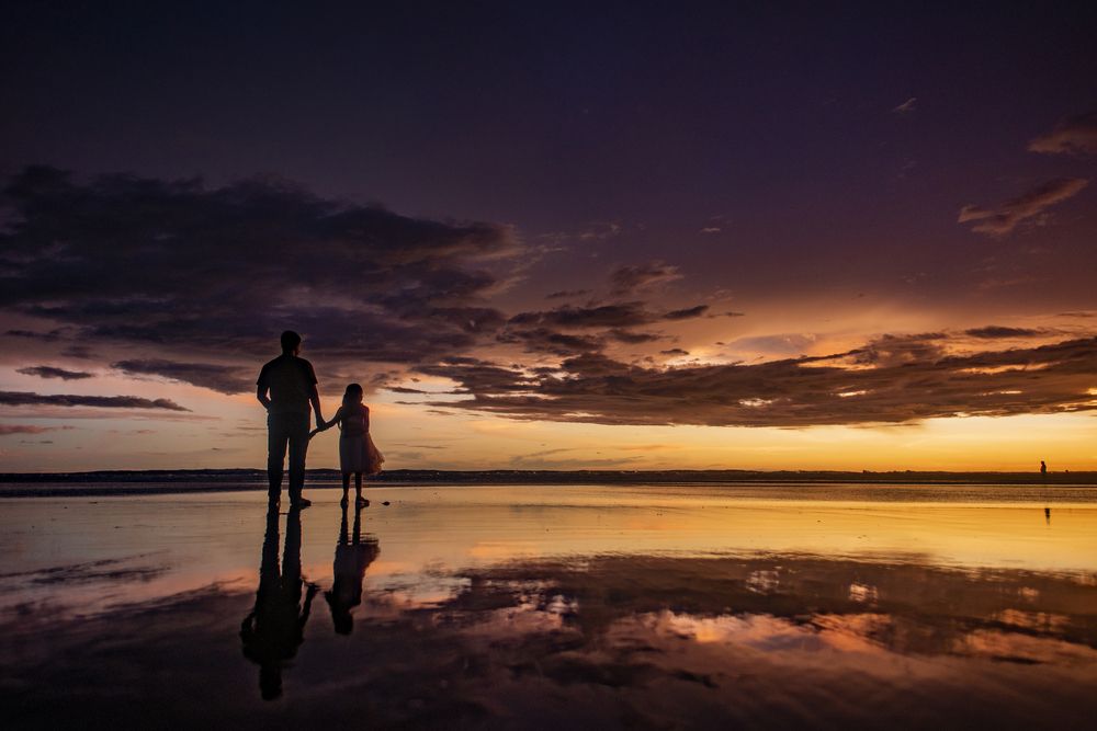 Hand in hand, against the canvas of a breathtaking sunset
