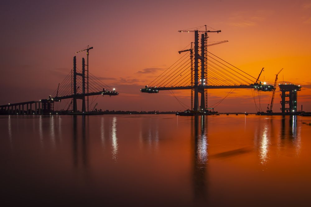 Sunset on the cable-stayed bridge construction site