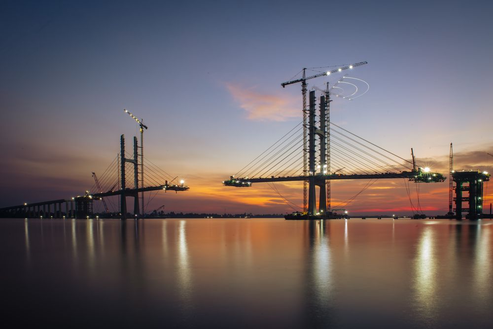 Sunset on the cable-stayed bridge construction site