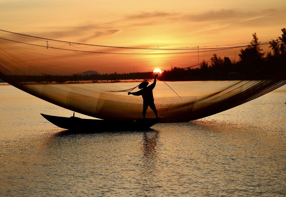 Fisherman at sunrise in Hoi An, Vietnam