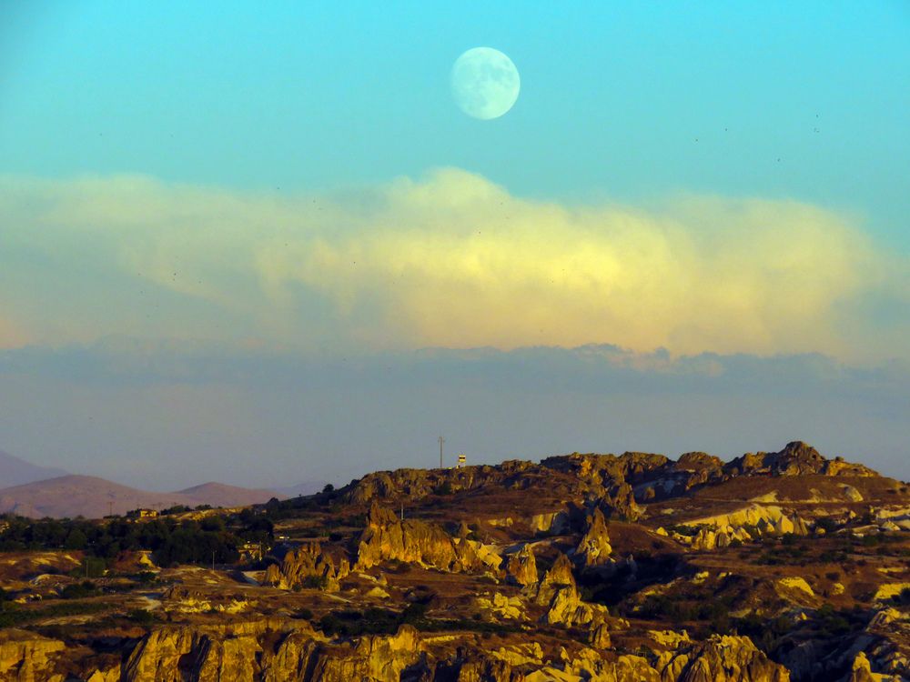Moon and cloud over valleys in Cappadocia