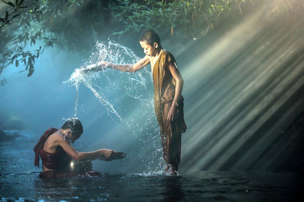 Novice buddhist monk splashing.
