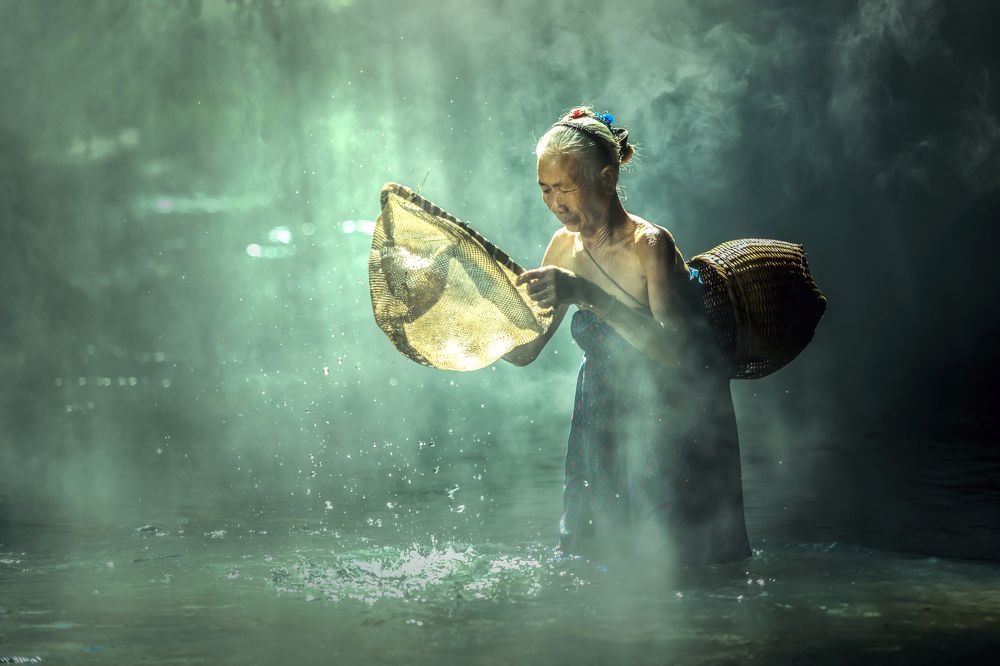 Old women are fishing to feed.