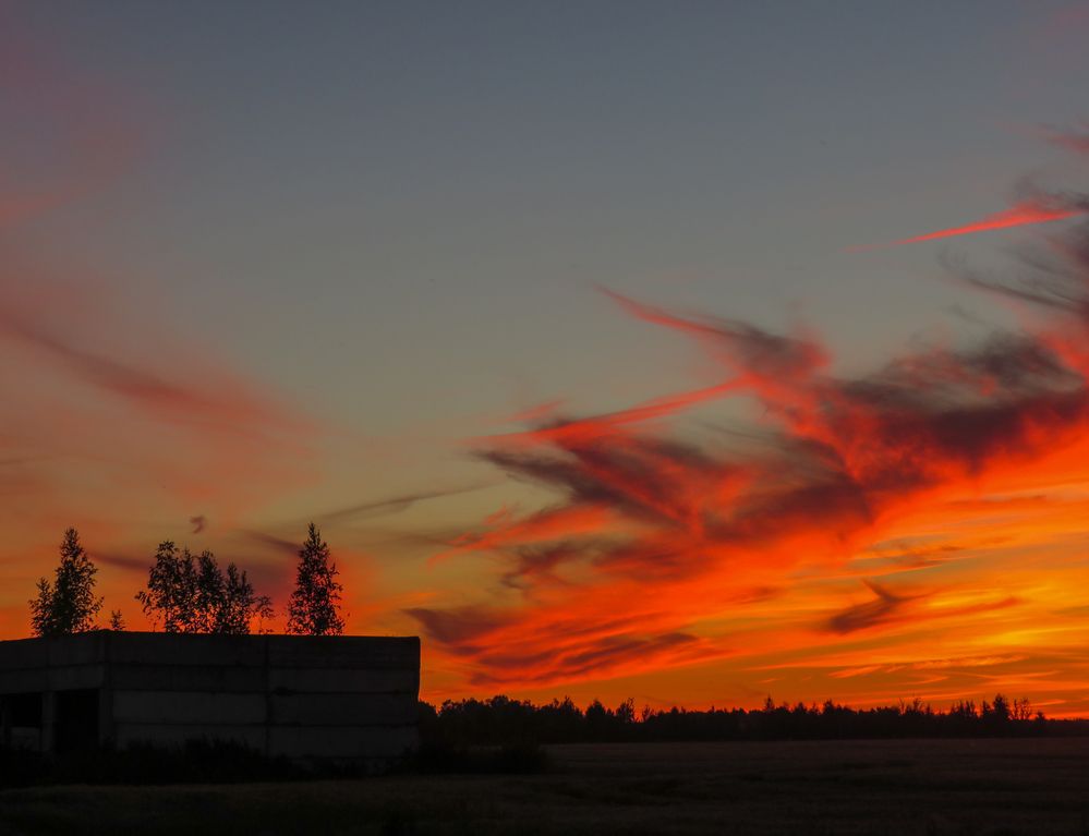 Fiery clouds in the rays of the setting sun