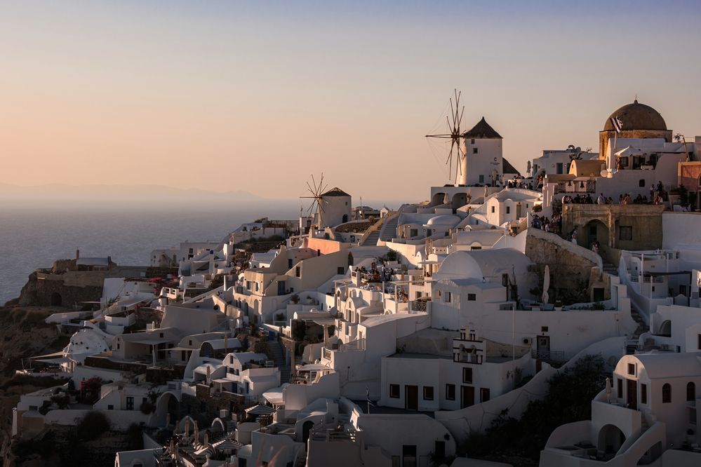 Sunset glow over Oia windmills