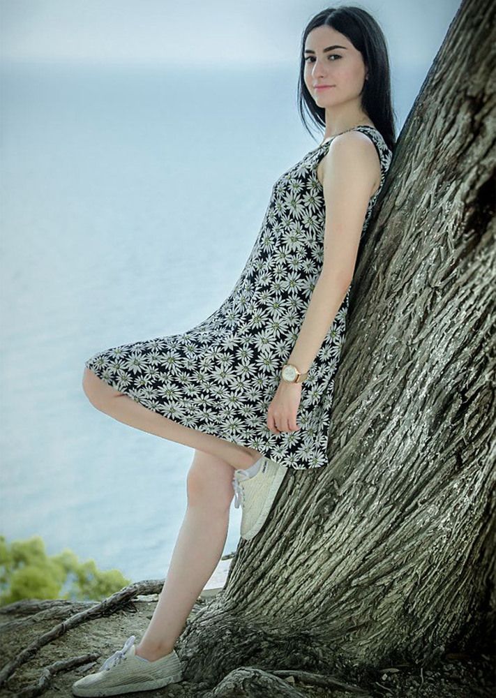 Woman Leaning on Tree