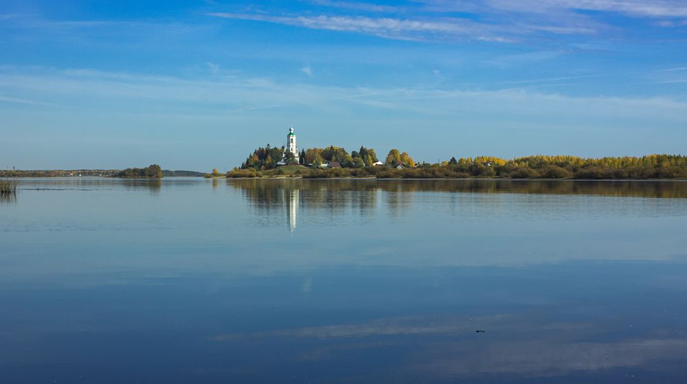 The Kubena River and the Church of Athanasius the Great in the distance on the shore on a clear October day