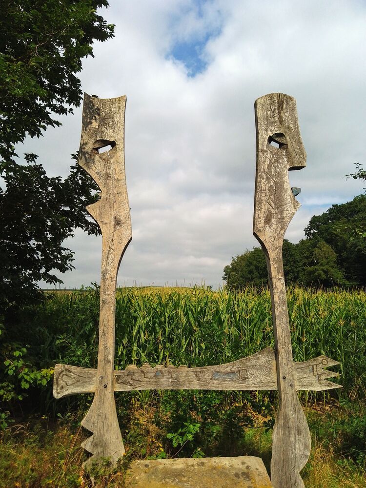 Wooden art by the field