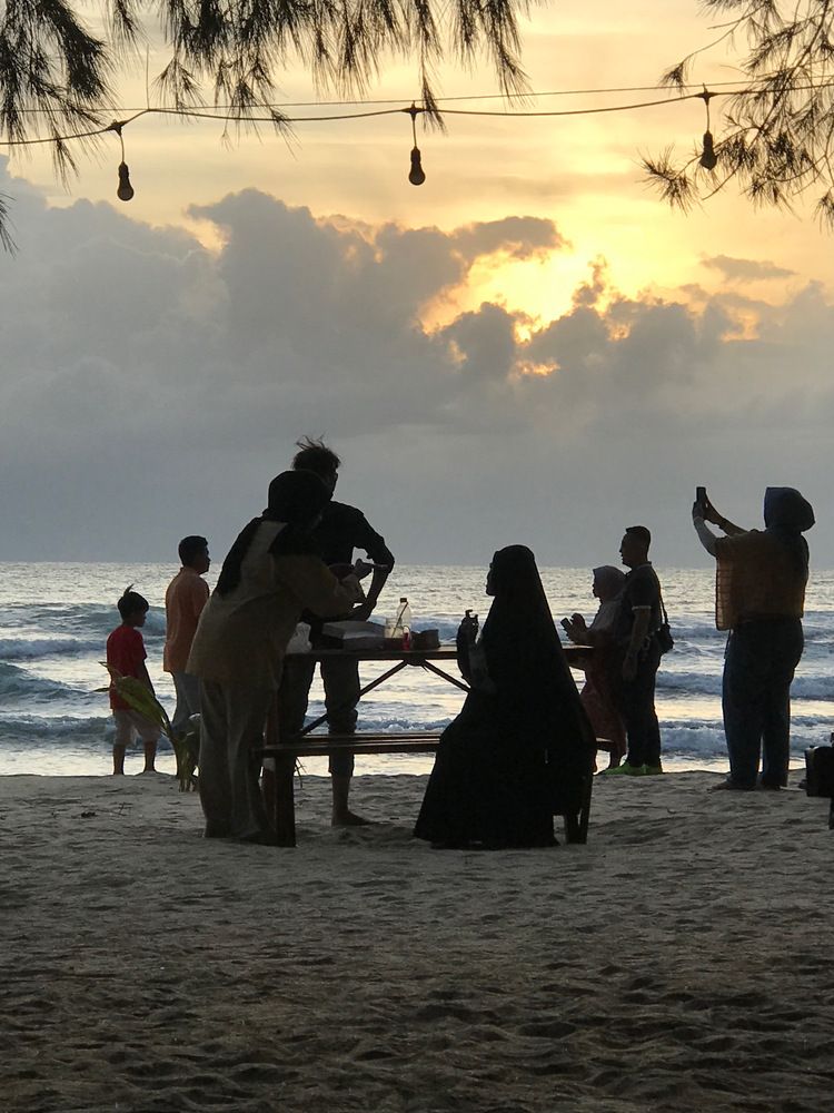 People in the sunset atmosphere of the beach