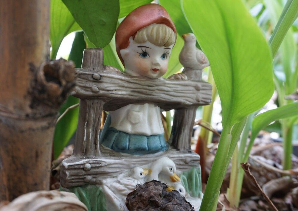 A little girl playing in the garden