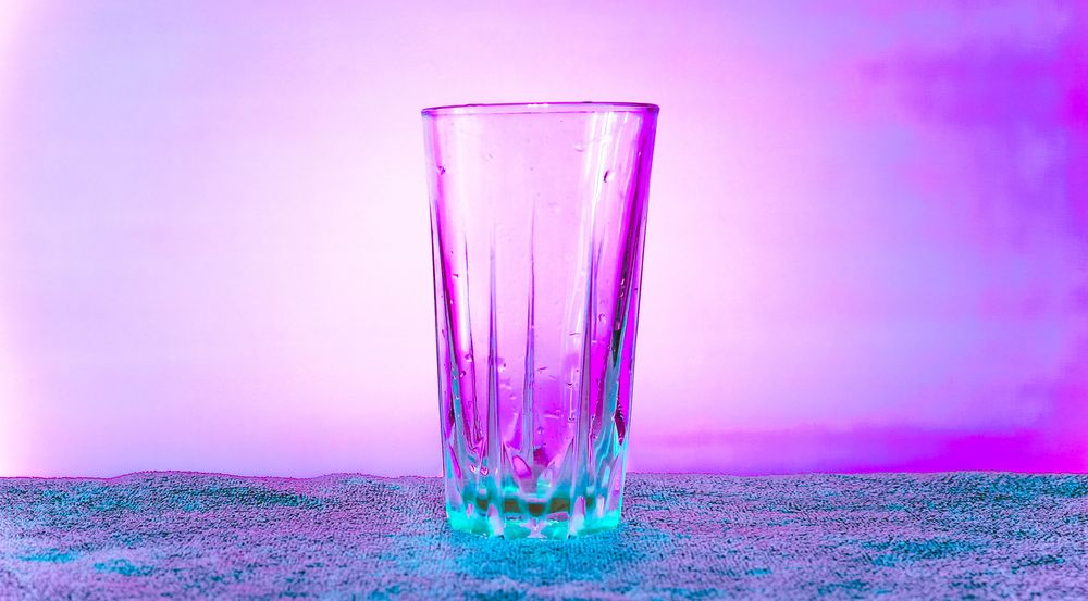 Transparent glass cup in pink and blue tones