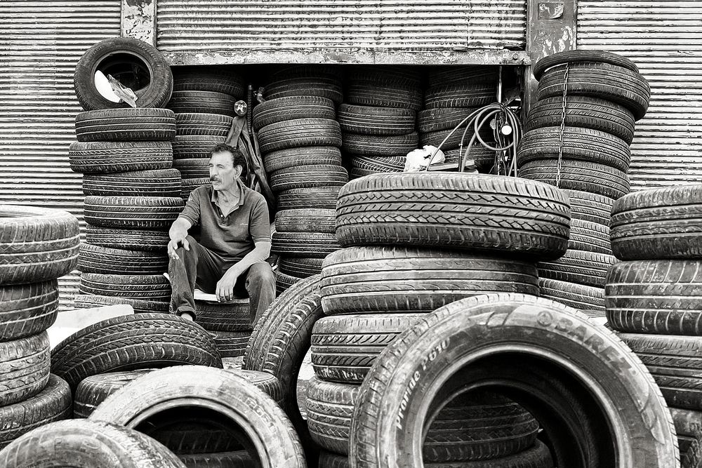 A man behind used tires