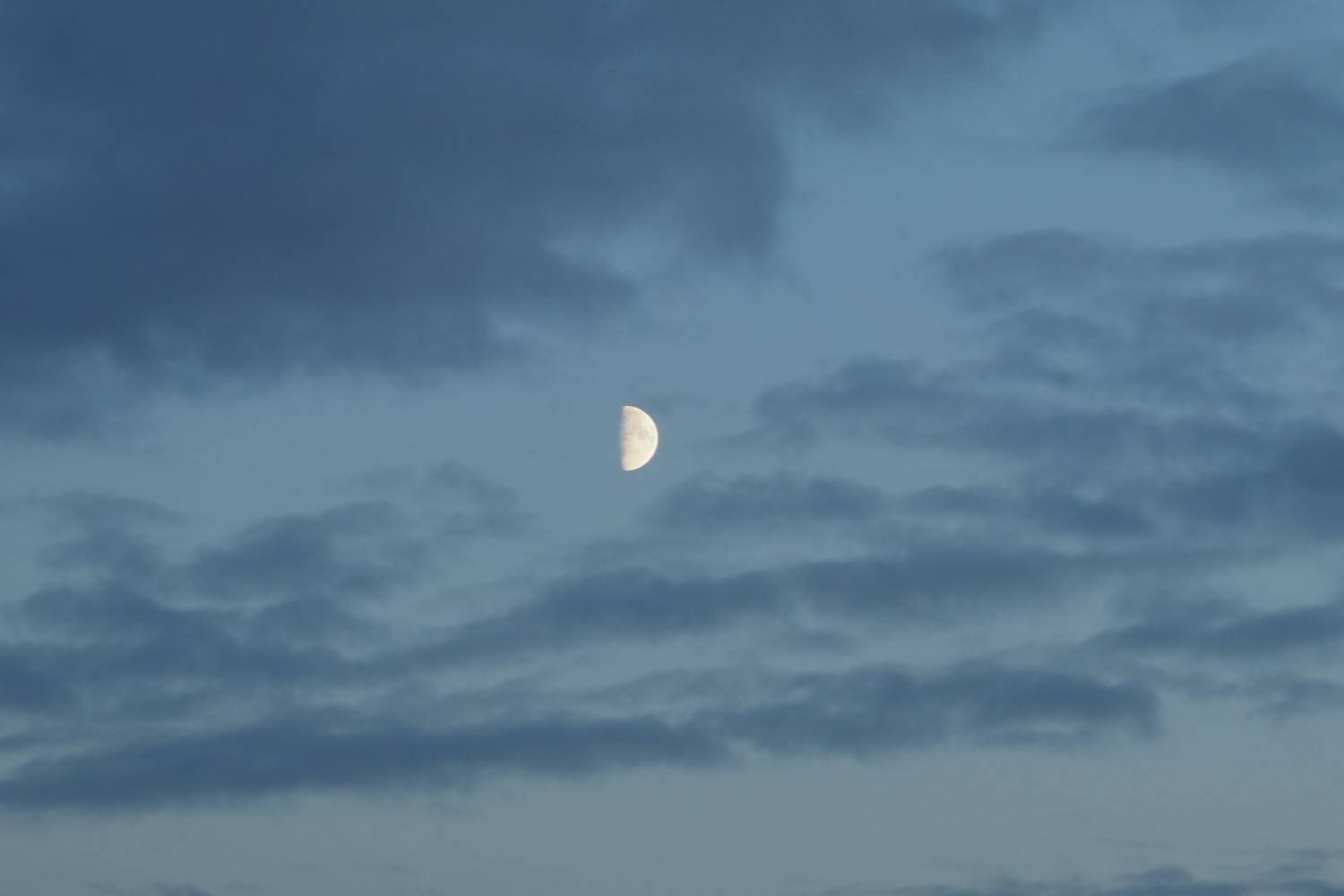 Moon in the blue sky with clouds background. Moon in the blue sky with clouds background.