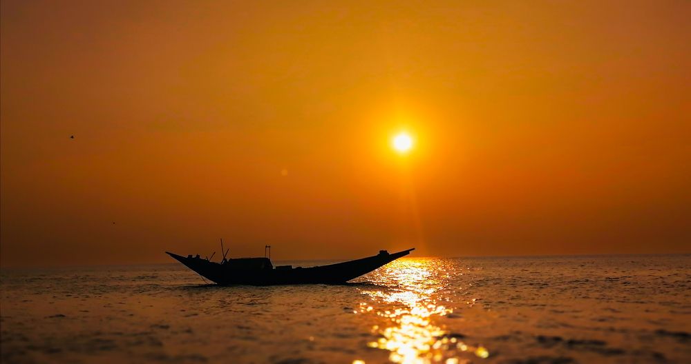 Solitary Boat Under a Golden Horizon
