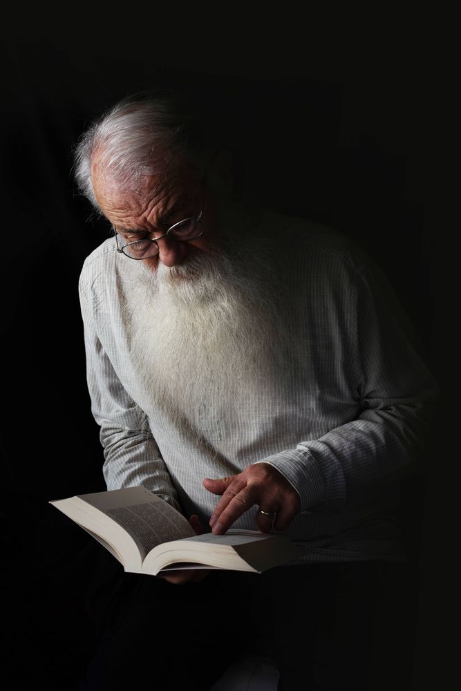 old man reading a book