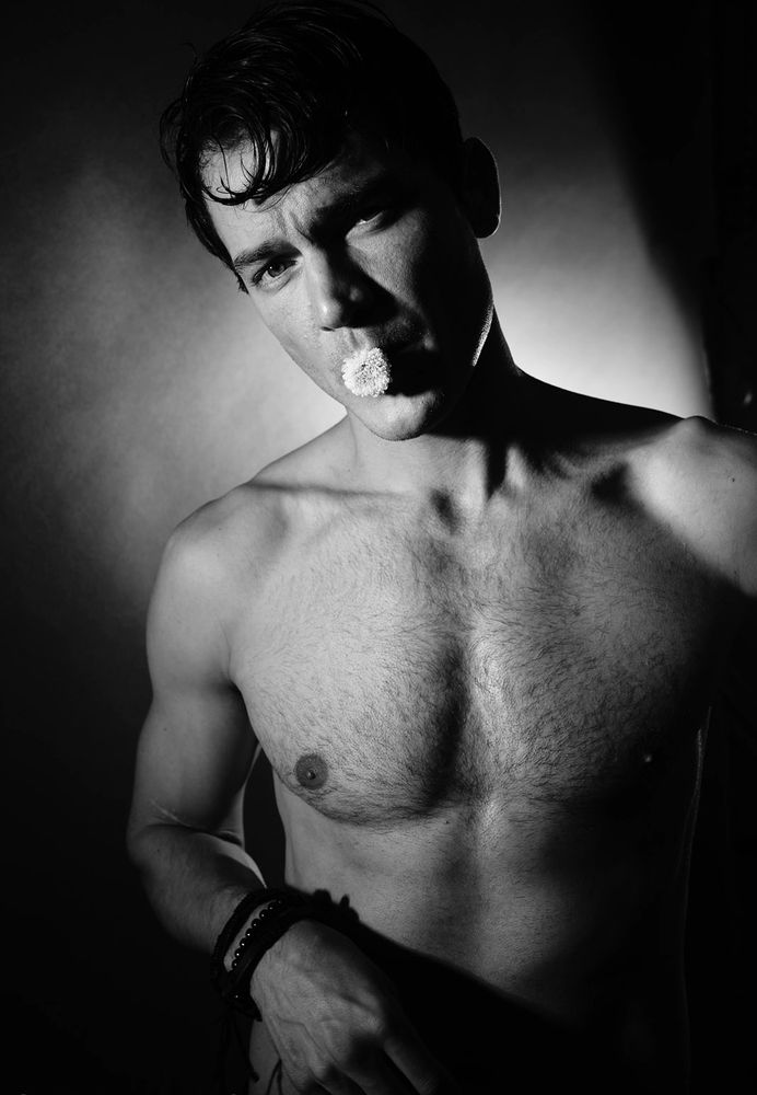 Male model and flower in mouth