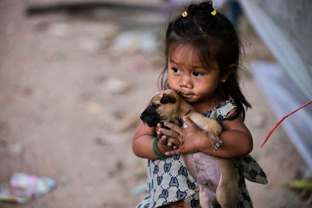 Cambodia girl with her puppy.