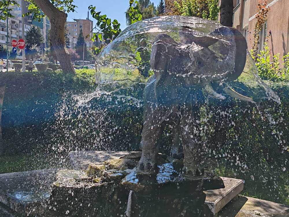 Statue of an elephant playing with water