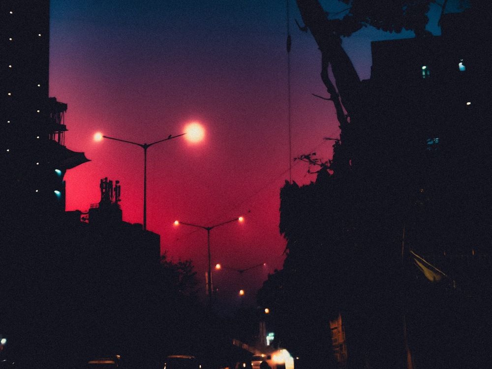 Street lights against the hues of the setting sun