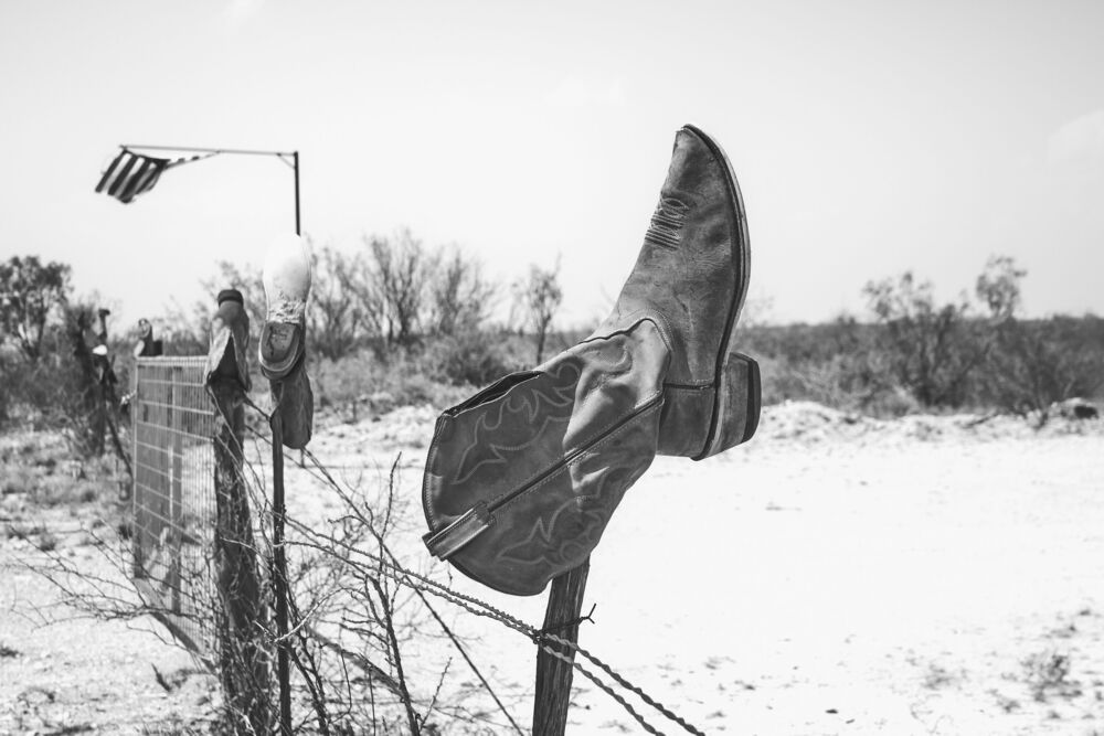 Boots, fence and flag