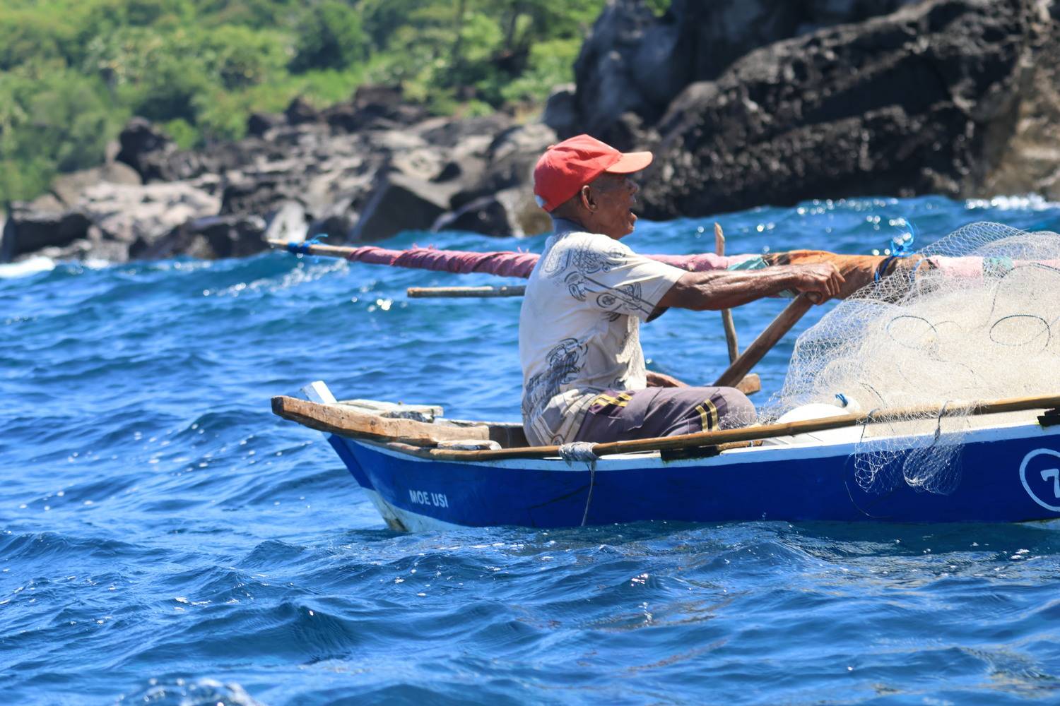 A fisherman on wooden boat