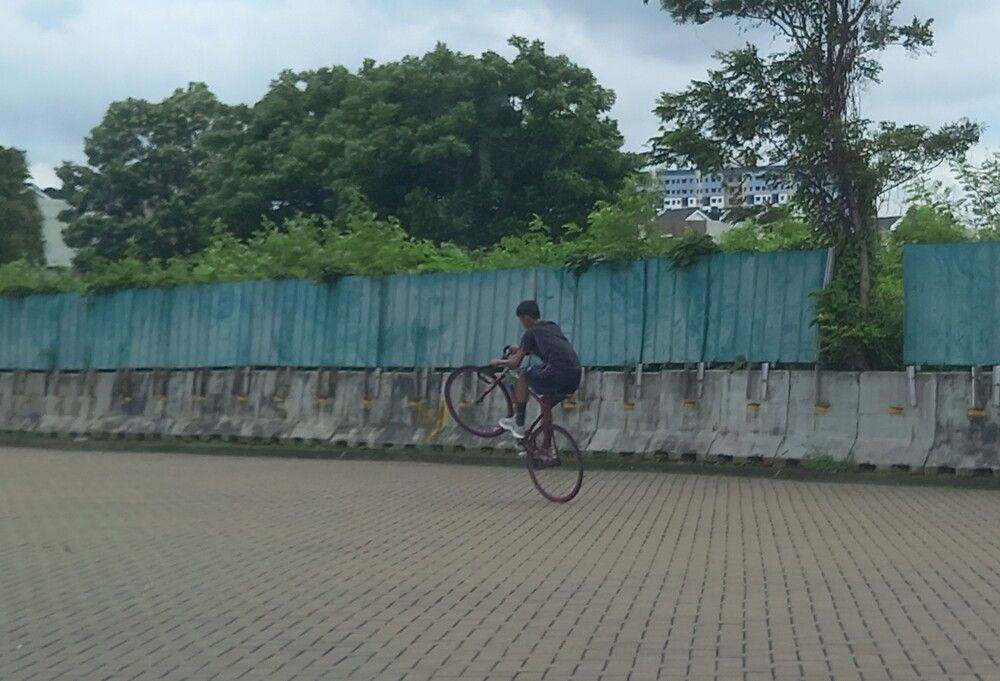 A boy practicing bicycle stunts