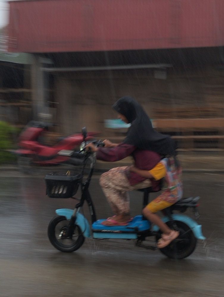Mother Bringing Her Daughter Taking Rain.