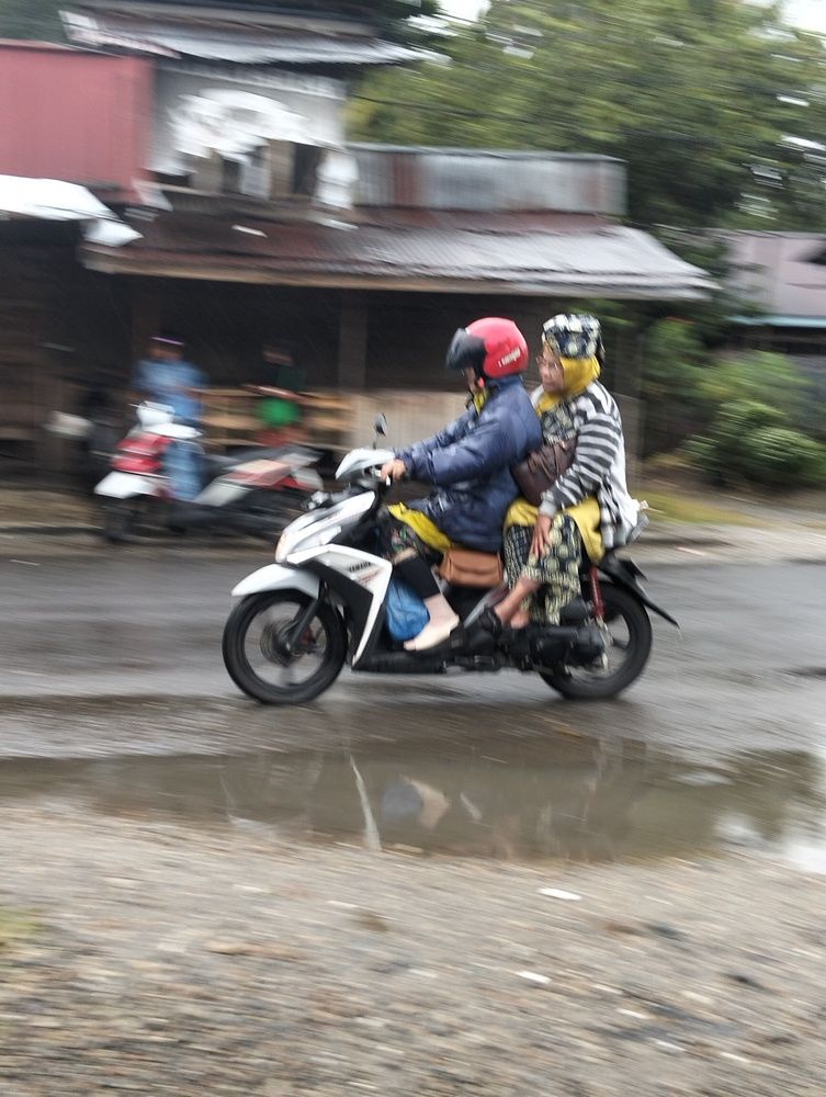 Two friends are together riding in A Rainy Day