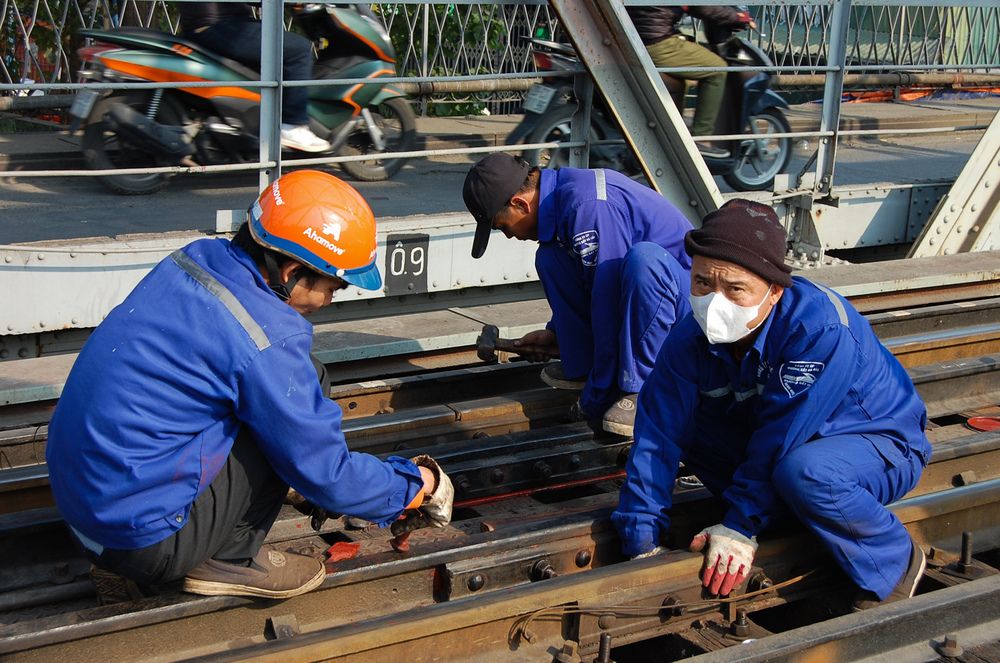 Workers repairing Long Biên Bridge in Hanoi.