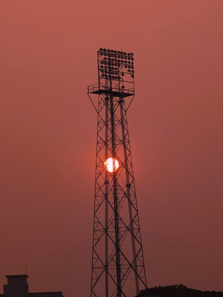 Rising sun through the light tower