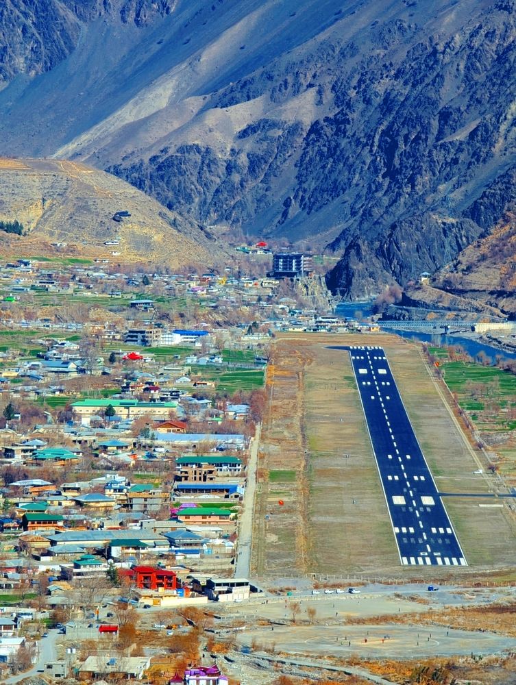 Chitral Airport — Gateway to the Mountains  Chitral Airport Above the River  Gateway to Chitral  Chitral Airport — Where the Valley Begins  A Gateway Between Mountains and River  Chitral Airport: A Gateway in the ValleyChitral, Chitral Airport, Pakistan,