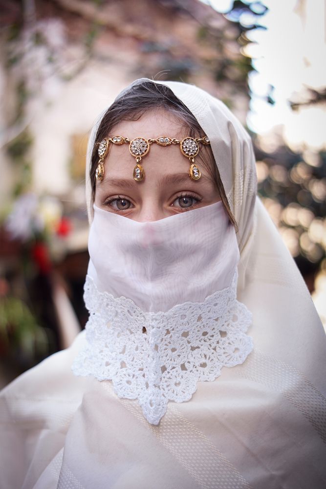 An Algerian girl in traditional clothing \"the haik\"