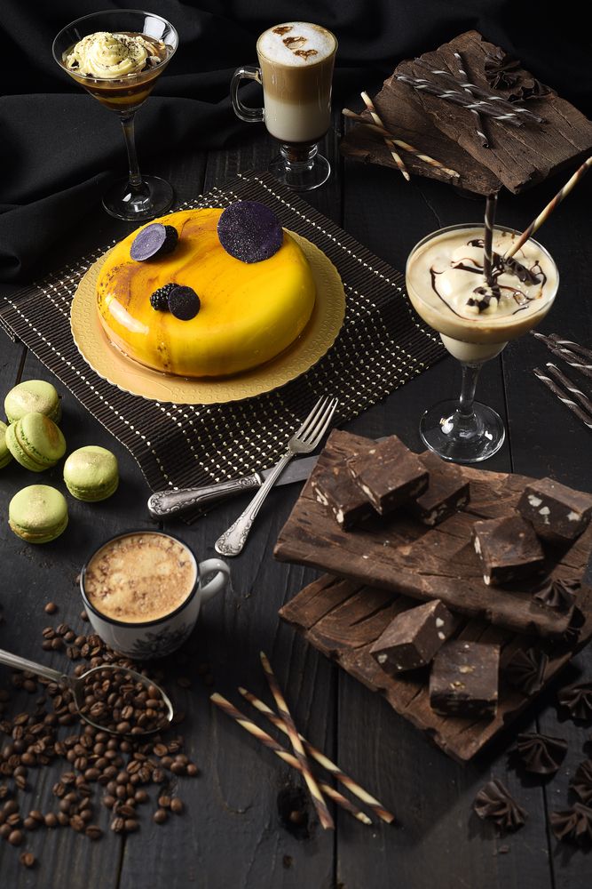 Luxury dessert table with brownies, macarons and coffee on rustic background