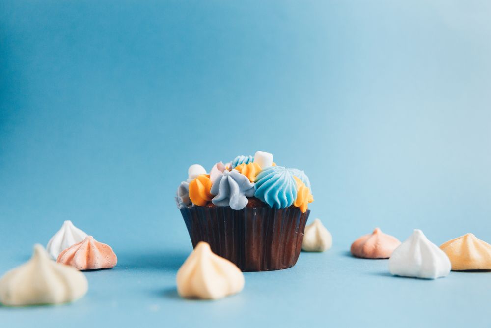 cupcake with multi-colored buttercream and meringue