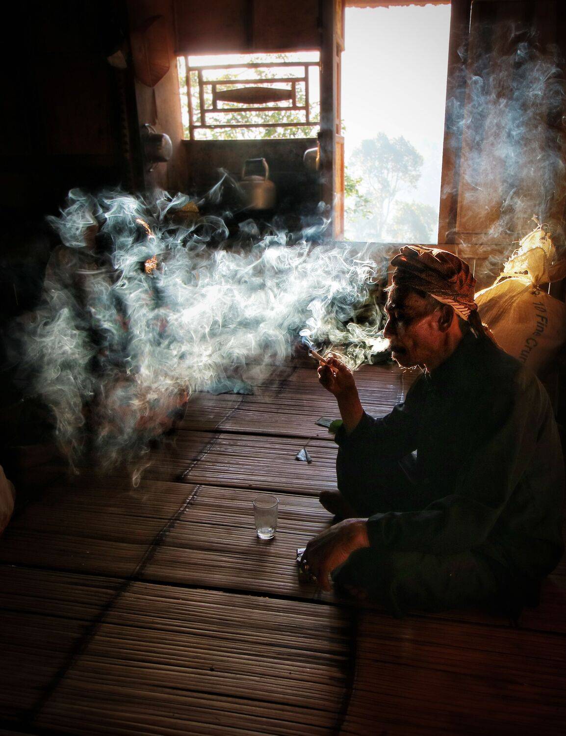 Cigarette glow in the hush of morning,