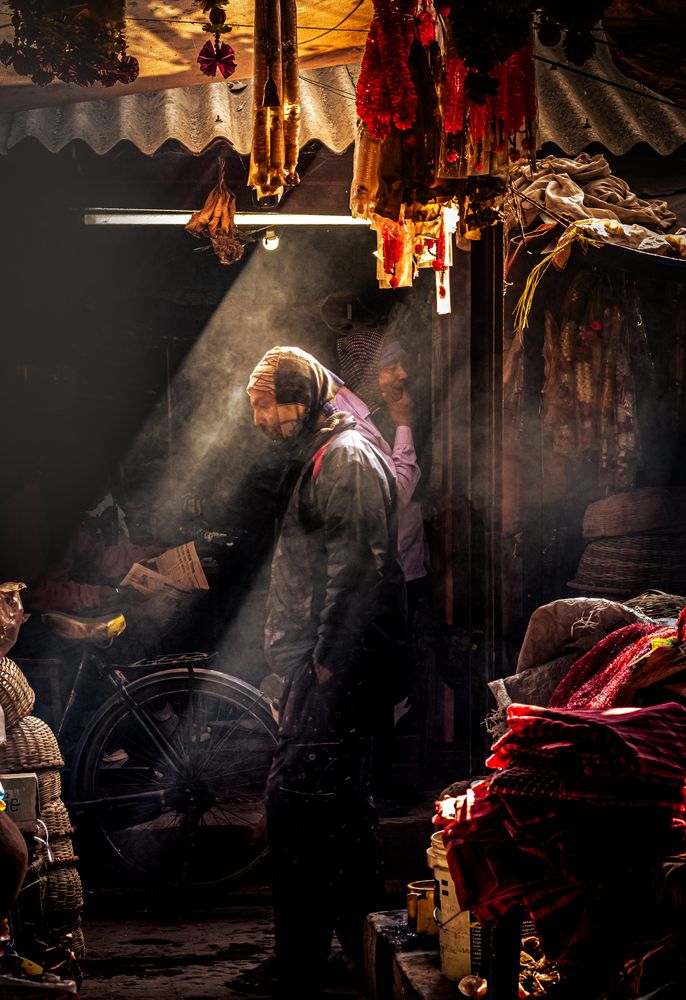 Light Through the Market Shadows ,Even in the darkest corners of the city, light always finds a face to fall upon.