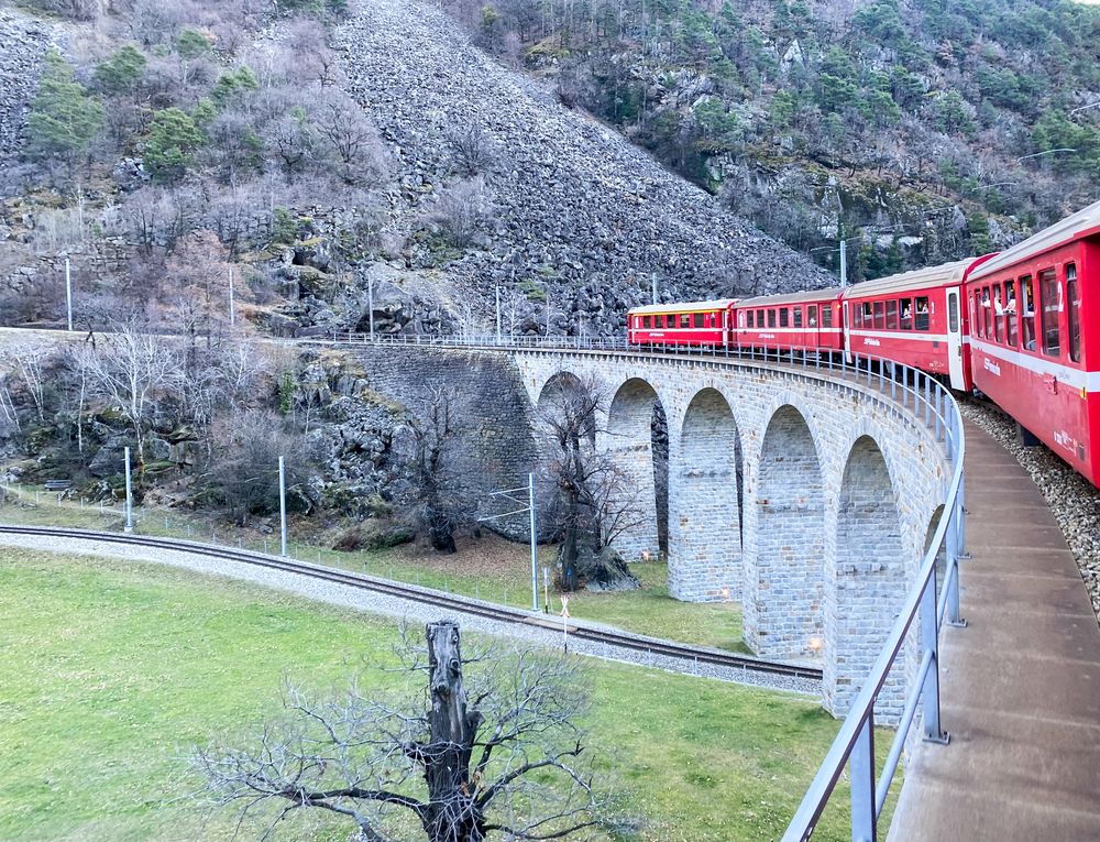 The famous Bernina Express train along a scenic route in the Swiss Alps
