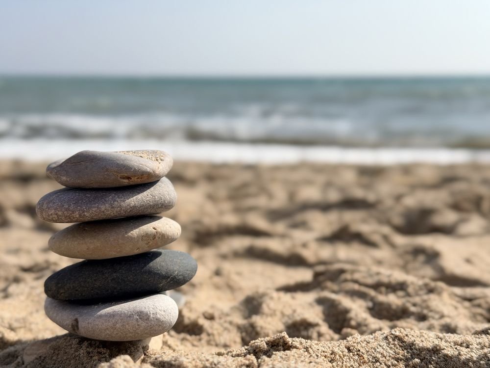 Serene Seaside Scene Featuring Orderly Pebbles And Warm Tones For Meditation