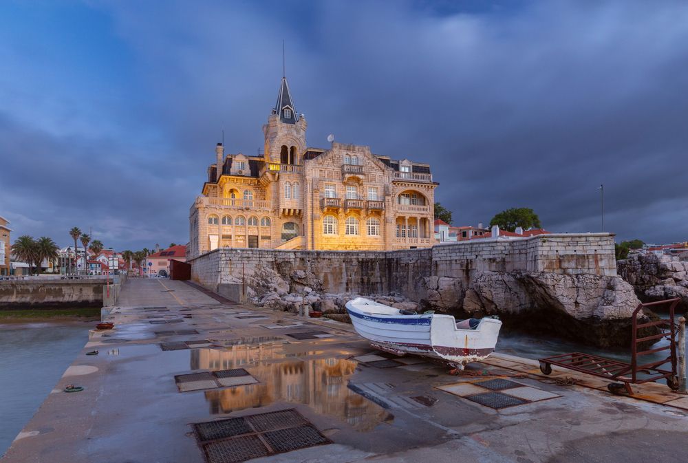 Santa Marta waterfront mansion under storm clouds in Cascais Portugal